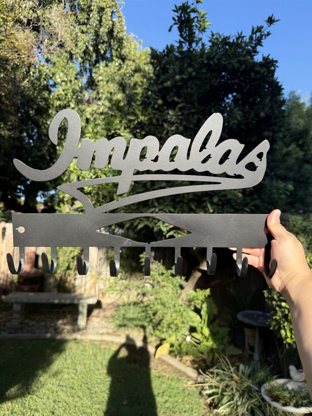 The word Impalas cut in flowing steel script above a bar.