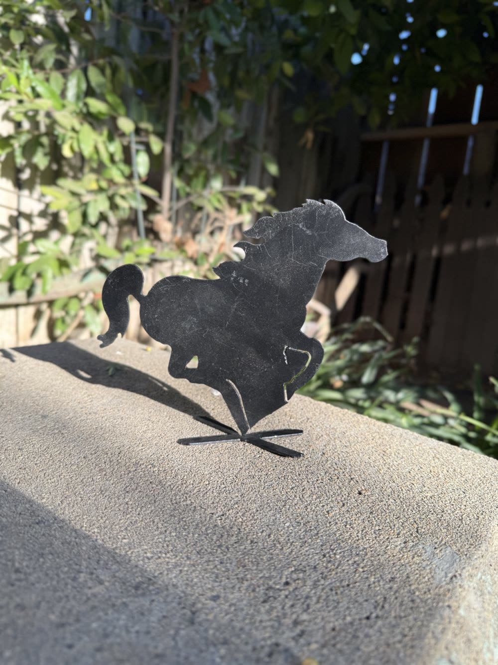 A running horse cut from steel.